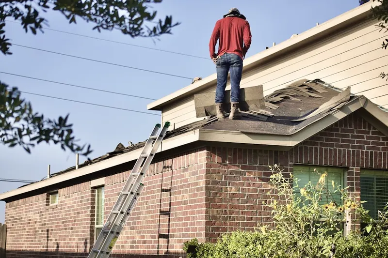 Professional roofer working on a residential roof in Lower Longwood